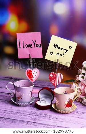 Decorative metallic lantern, message holder and artificial flowers on bright background