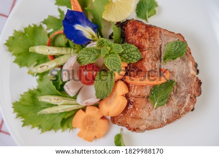 Pork Steak with Tomato, Carrot, Red Onion, Peppermint, Butterfly Pea Flower, and Lime.