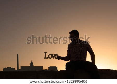 man in front of washington city skyline in usa