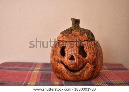 Ceramic pumpkin for halloween decoration, smiling on a table