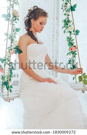 Wedding day and beautiful bride in studio. Beautiful young bride with wedding makeup and hairstyle. Portrait of young gorgeous bride. Wedding. Royalty-Free Stock Photo #1830009272