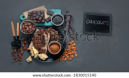 Delicious chocolate bars and pieces with nuts. Top view, copy space