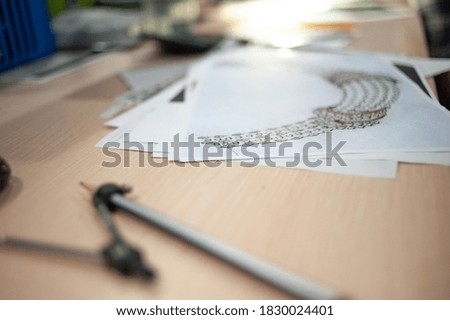 An office desk with drawing tools and a drawing