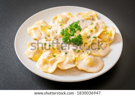 ravioli pasta with mushroom cream sauce and cheese - Italian food style Royalty-Free Stock Photo #1830036947