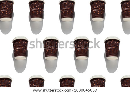 Coffee to go regular pattern with natural shadows on white background top view. Brown paper cups with lids for take away hot drinks in cafe shop. Lifestyle concept flat lay wallpaper for desktop.