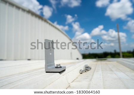 installing metal sheet bar clamp and grounding system by barehanded stock photo