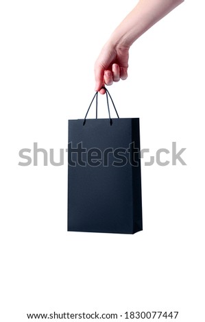 Mock-up Black Shopping Paper Bag in Woman Hand on White Background