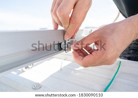 installing metal sheet bar frame and grounding system by barehanded stock photo