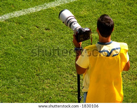 A sports photographer working at a soccer game
