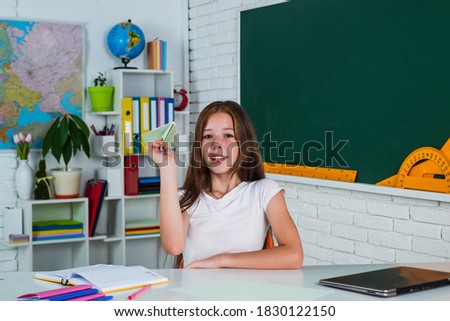 Excited about knowledge. kid in classroom with chalkboard. child hold paper plane. back to school. formal education in modern life. home schooling. childhood development. get knowledge through study.