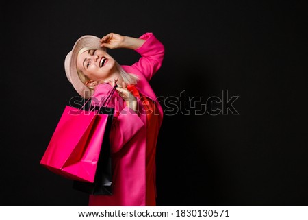 Elegant woman holding black shopping bags, black friday concept