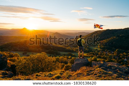 Happy father, flying kite in the field at sunset. Silhouette man with kite flying over his head. In the background the mountains during the colorful autumn Royalty-Free Stock Photo #1830138620