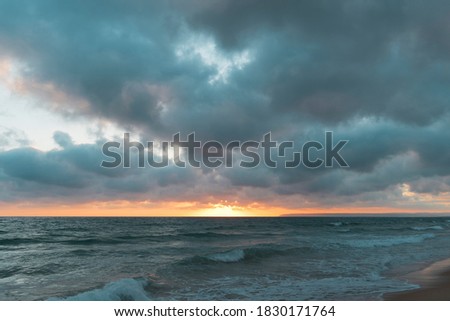 nice cloudy sunset on the beach forming a storm