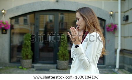Disappointed business woman arguing by mobile phone outdoors. Serious businesswoman calling phone at city street. Frustrated worker talking phone while walking outside. Displeased woman call cellphone