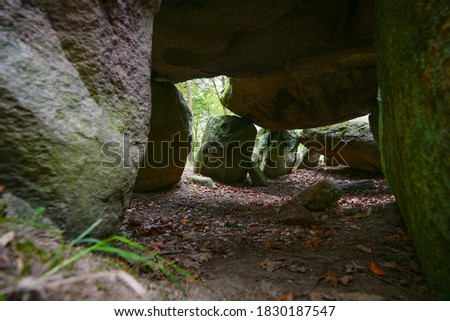 View into a prehistoric megalithic tomb or dolmen, an excavated and reconstructed passage grave from larges stones in the forest of Klein Gornow, Sternberg, Germany, copy space, selected focus, narrow