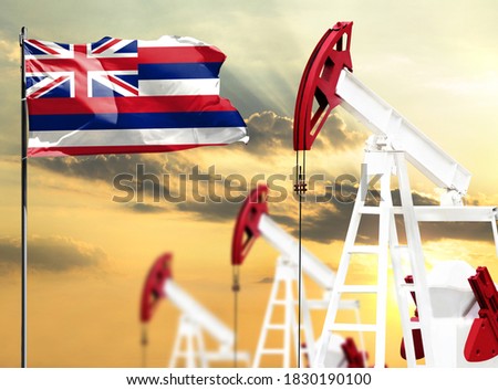 Oil rigs against the backdrop of the colorful sky and a flagpole with the flag State of Hawaii. The concept of oil production, minerals, development of new deposits.