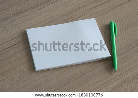 torn paper and pen on wood background with copy space for text