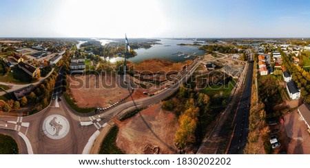 Aerial panoramic view of the largest finnish flag in the world and the tallest flagpole in Europe against of Hamina city, Finland. The flag pole is 100 meter high.