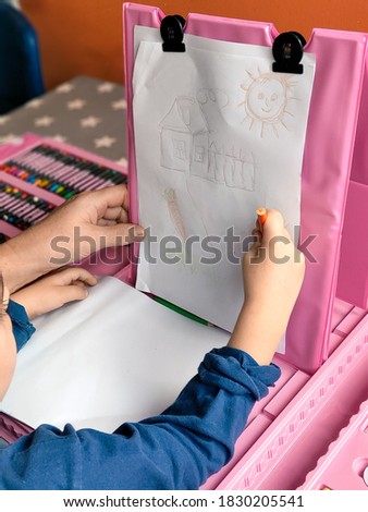 grandmother and grandson drawing pictures with colored pencils  and brushes
