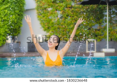 Portrait beautiful young asian woman relax smile leisure around outdoor swimming pool in holiday vacation travel trips