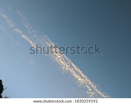 row of clouds in the clear sky