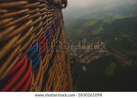 beautiful view from the basket of an air balloon, with the city and countryside underneath