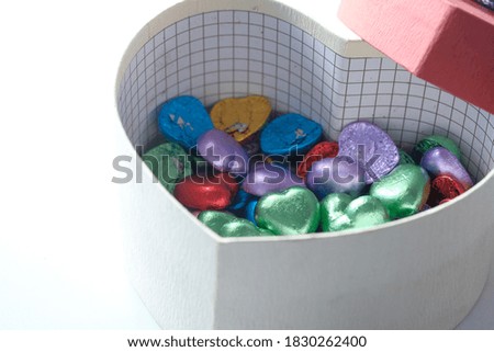  small heart shape gift with candy on white background 