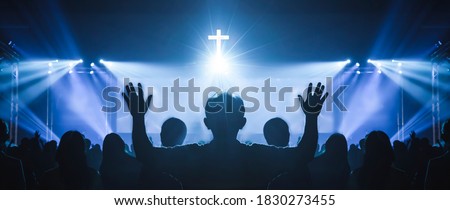 Church worship concept: Christian worship with raised hand at the at the cross cross background Royalty-Free Stock Photo #1830273455