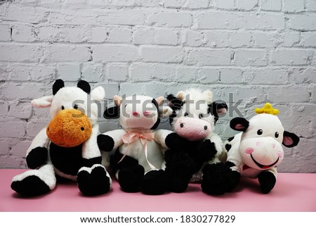Collection Cute Funny cow doll with space copy on white brick and pink background