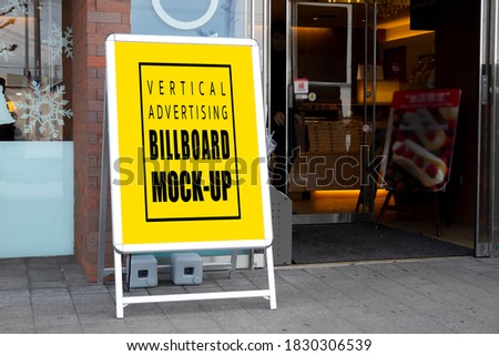 Mock up blank outdoor signboard standee with clipping path, empty board in metal frame stands on walkway at front of restaurant for insert text for announcement or information promotion