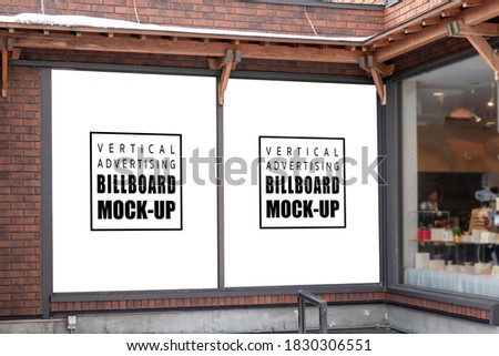 Perspective two mock up vertical billboard with clipping path on the wall of building,  near glass window of restaurant, Empty space to insert advertising, announcement or information promotion