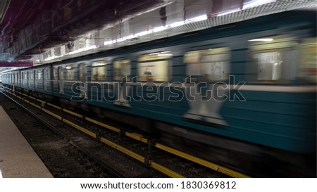Photo of a train in motion with a long exposure. The picture shows a trace of a passing train. Picture is dynamic, so the train is in motion captured.