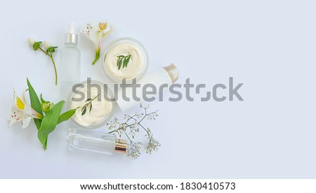 cosmetic cream, flower on white background