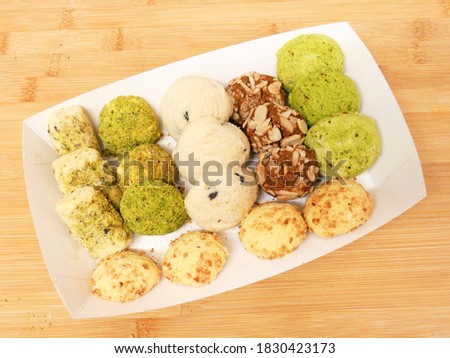 Turkish Desserts Mxed kurabiye in a white take away box on a wood background