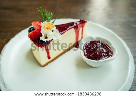 Close-up picture of delicious cakes on beautifully decorated ceramic plates and bokeh background.