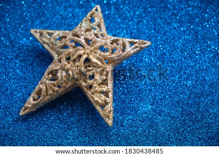 Christmas card copy space, Golden star decoration on blue glitter background