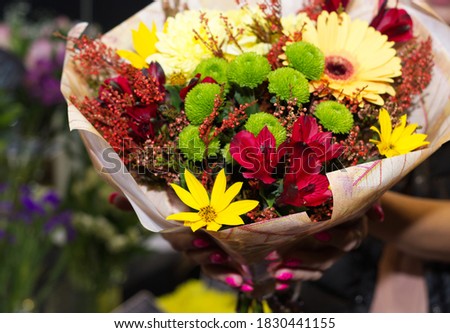 beautiful, autumn bouquet in female hands, in a flower shop. Bright, unusual bouquet, floral arrangement for a holiday. Flower trade, private business, losses, loss of customers