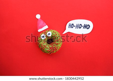 xmass new year donat santa claus with party hat. for present card or invitation of party. festival red background