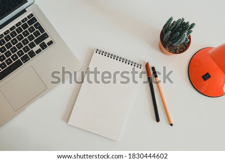 office desk with laptop, empty notebooks and plant on white background. Blank notebook, pen, keyboard on with table. Planning notes writing concepts.