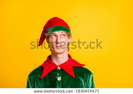Photo of young intelligent guy look up empty space wear elf velvet green costume headwear specs isolated yellow color background