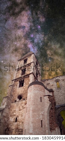 Composite photo of a night shot of a medieval, romanesque church under the Milky Way.