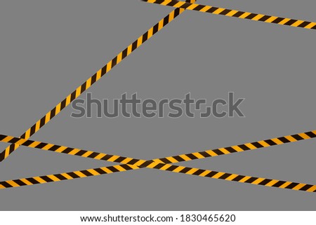 Black and yellow warning lines of barrier tape prohibit passage. Barrier tape on gray isolate. Barrier that prohibits traffic. Danger unsafe area warning do not enter. Concept of no entry. Copy space