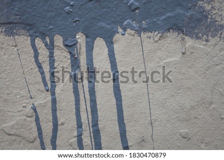 Dirty gray wall with paint splash. Industrial urban background.