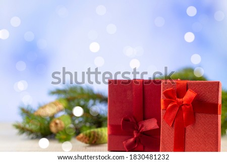 Festive Christmas background. New Year's and Christmas. Christmas card background. Christmas theme wallpaper in the apartment lay on top. Two gifts red
