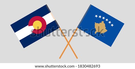 Crossed flags of The State of Colorado and Kosovo