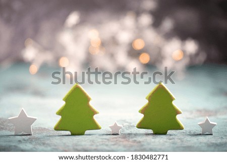 Christmas trees and star with blury lights in the background, greeting card, empty copy space