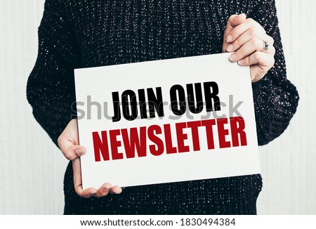 JOIN OUR NEWSLETTER text on notepad on women hands
