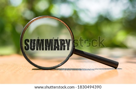 The word Summary on magnifier glass on wooden table. Business concept. Royalty-Free Stock Photo #1830494390