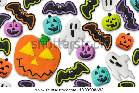 Halloween pumpkin Jack-o-lantern cookie and candy. Trick or treat. Happy Halloween. Flat lay, top view. Photo good for greeting card, billboard, poster. 