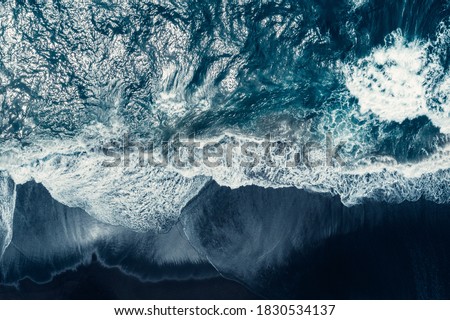 Aerial drone view of Atlantic ocean waves washing black basaltic sand beach, Iceland. Royalty-Free Stock Photo #1830534137